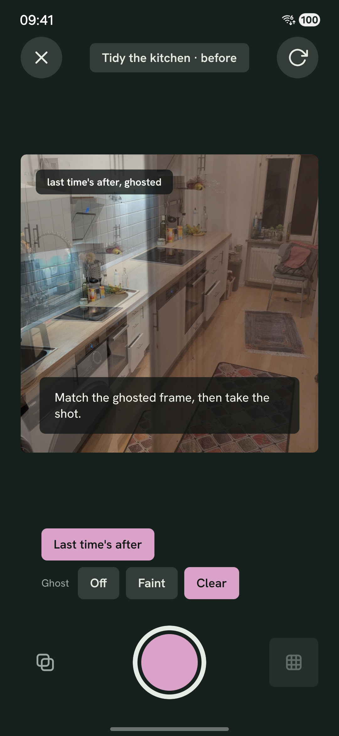 The camera before the before photo: last time's after lies half transparent over the viewfinder, which still points crookedly at the same kitchen. Below it, the overlay setting, on its strongest.